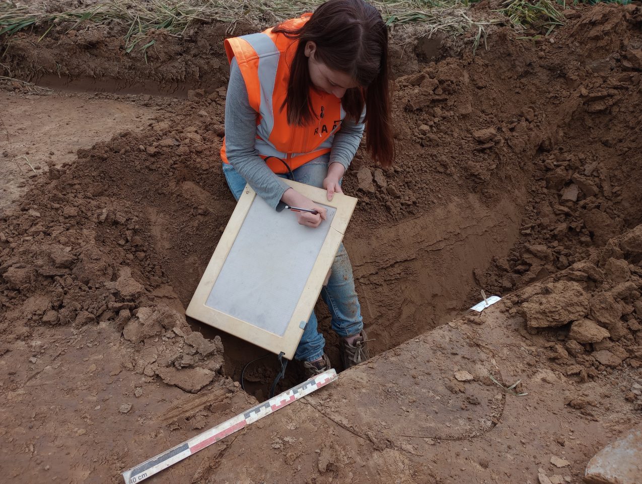 Archeologe aan het werk tijdens archeologisch onderzoek Lanakerveld