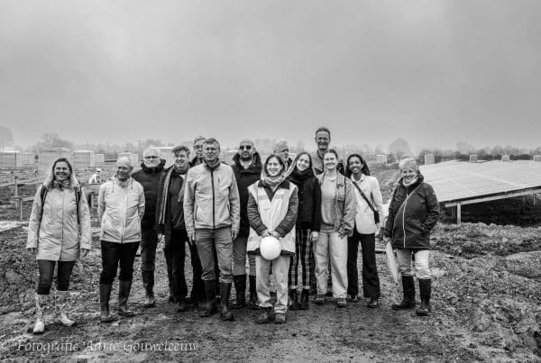 Group photo of attendees at Wijkerbroek Solar Park, discussing renewable energy initiatives and stakeholder participation